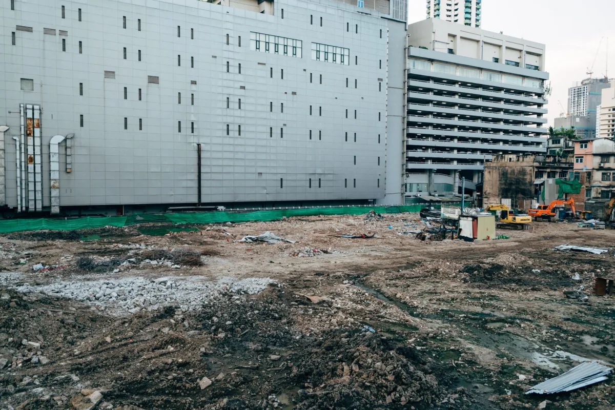 Demolition and construction site next to modern buildings, showing the kind of existing conditions that are scanned