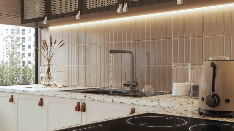 Photorealistic close-up rendering of a kitchen with a terrazzo worktop, tiled splashback and warm under-cabinet lighting